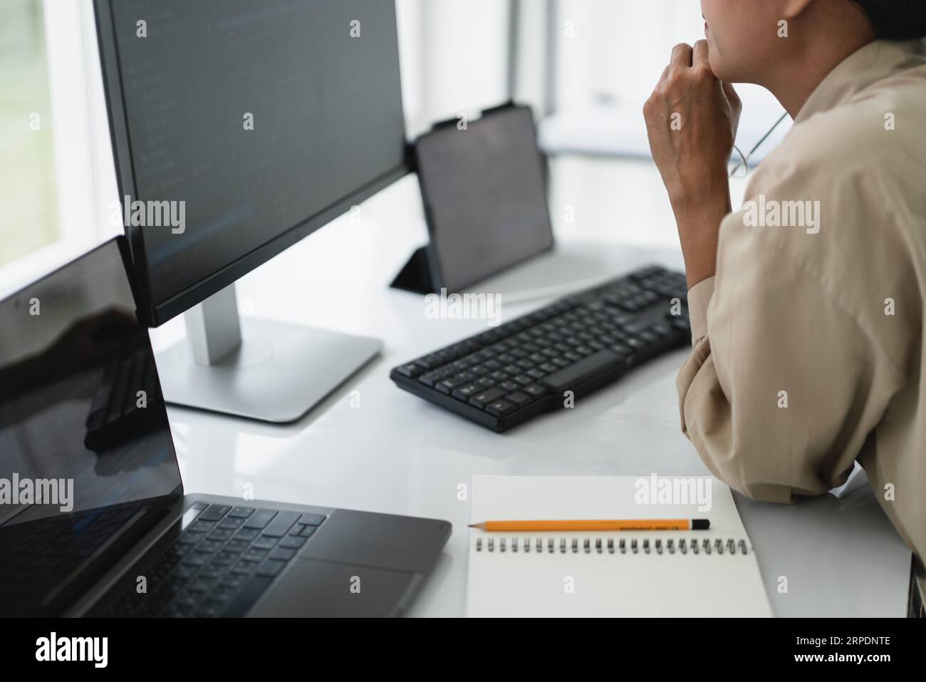 Developer programmer checking code on monitor while programming to developing web and application. Stock Photo