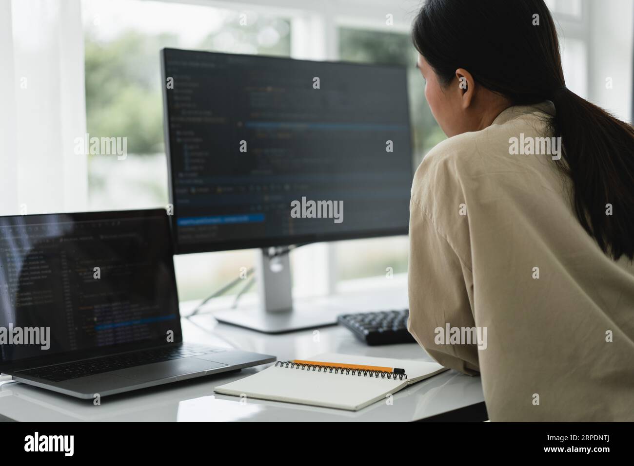 Developer programmer checking code on monitor while programming to developing web and application. Stock Photo