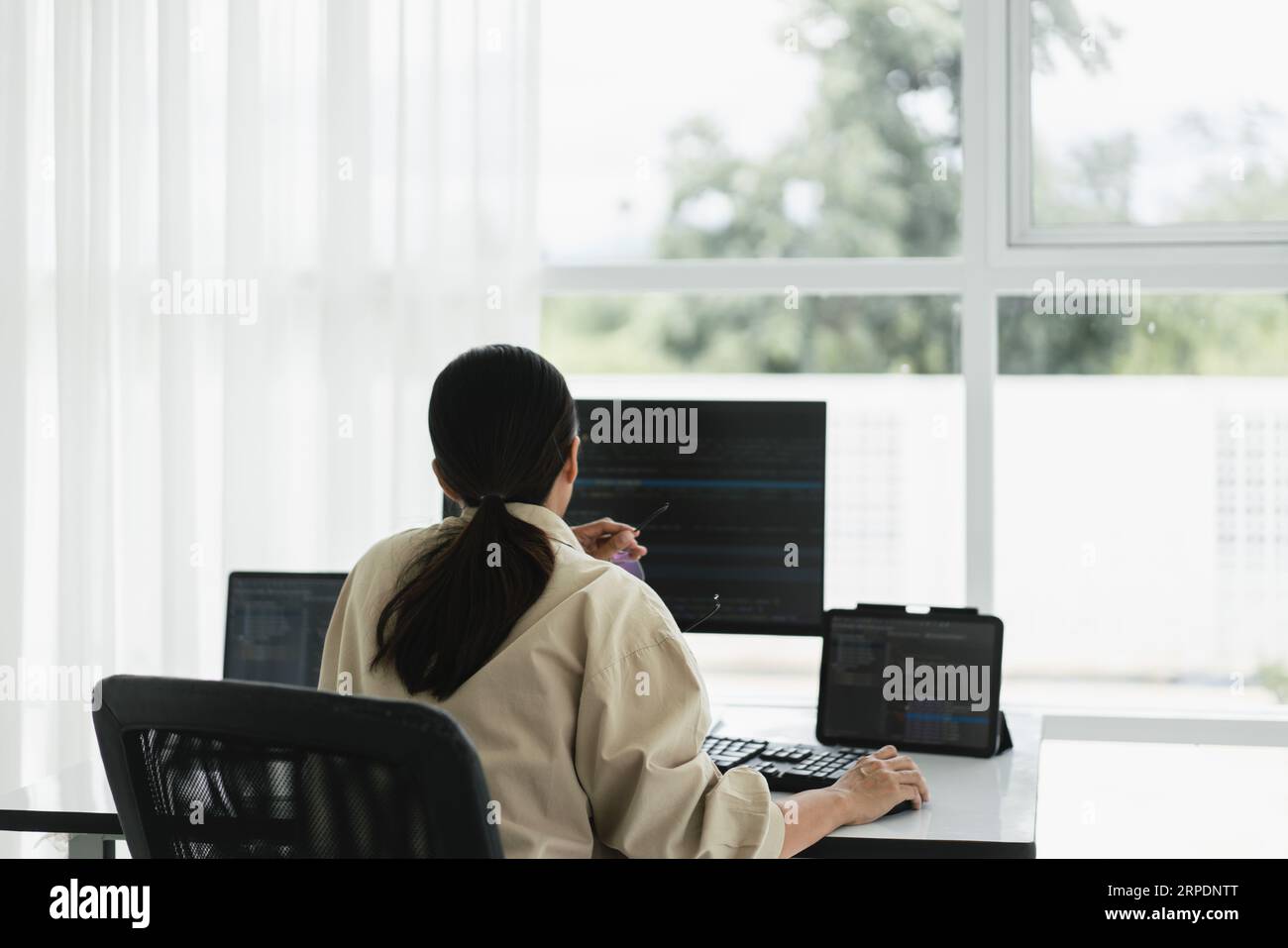 Developer programmer use mouse and checking code on laptop while programming to developing website. Stock Photo
