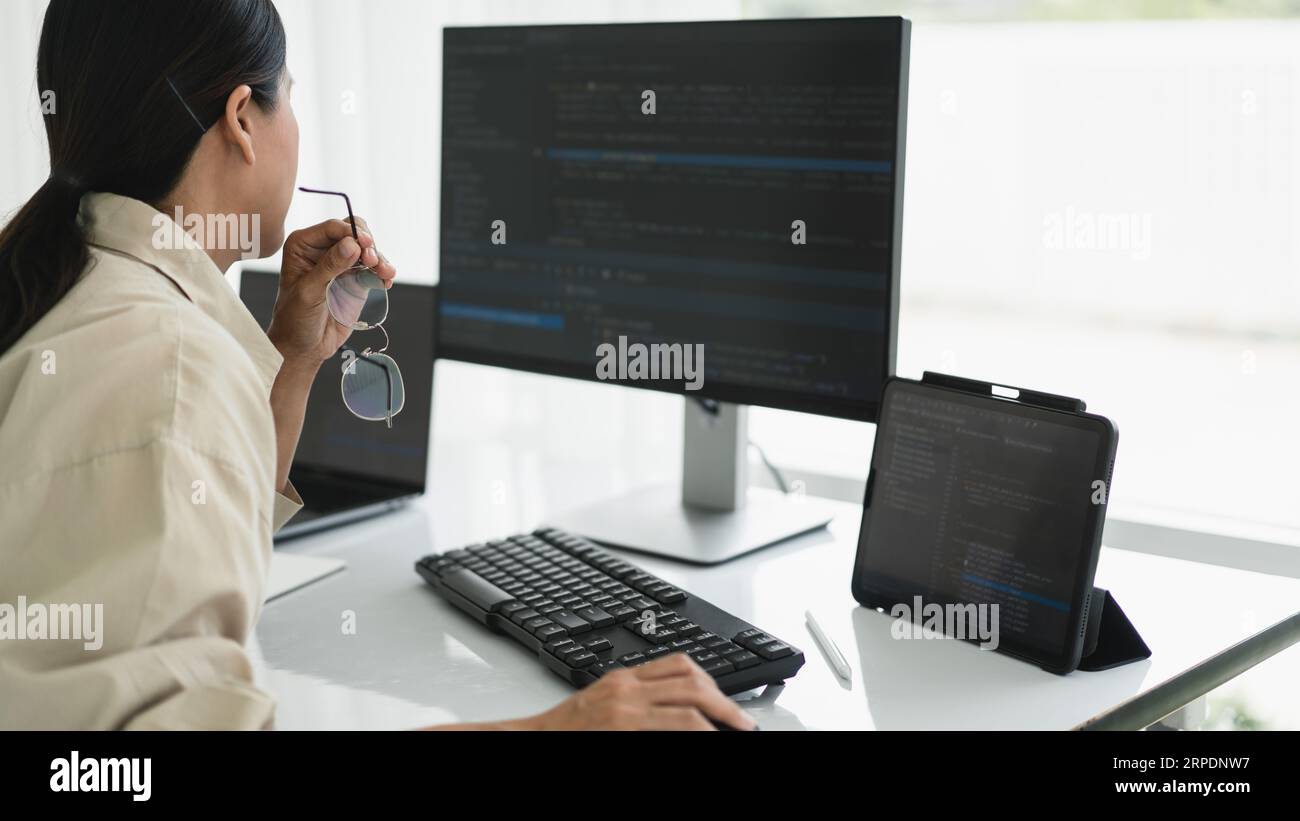 Developer programmer working to checking code on monitor while programming to developing website. Stock Photo