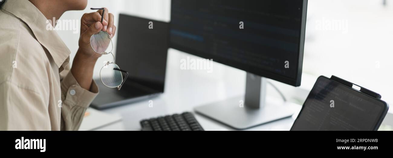 Developer programmer working to checking code on monitor while programming to developing website. Stock Photo