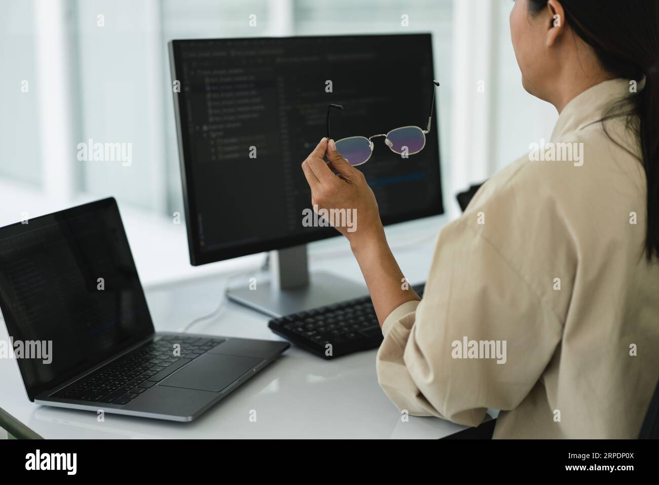 Developer programmer working to checking code on monitor while programming to developing website. Stock Photo