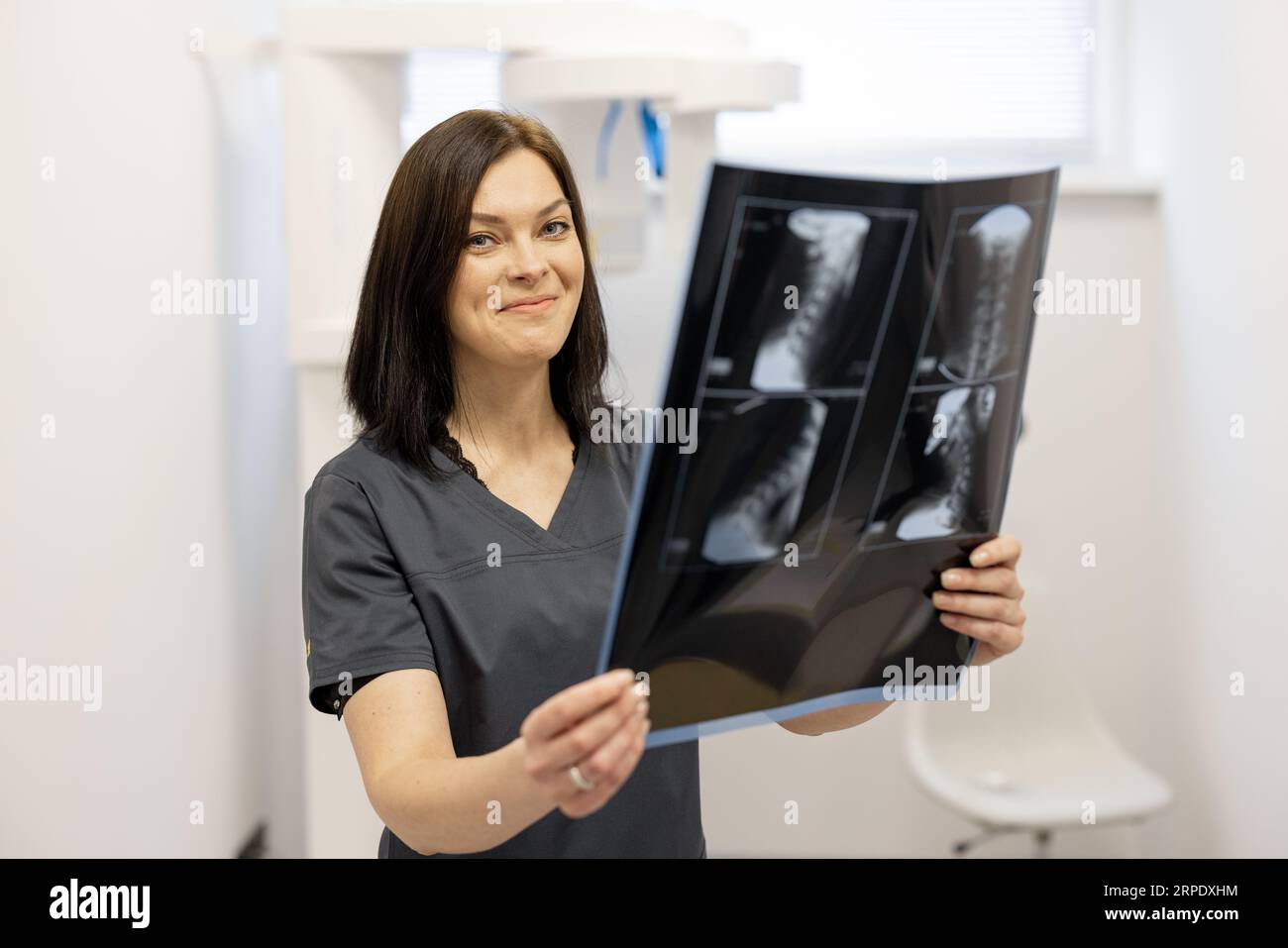 Doctor examines an x-ray of the cervical spine Stock Photo