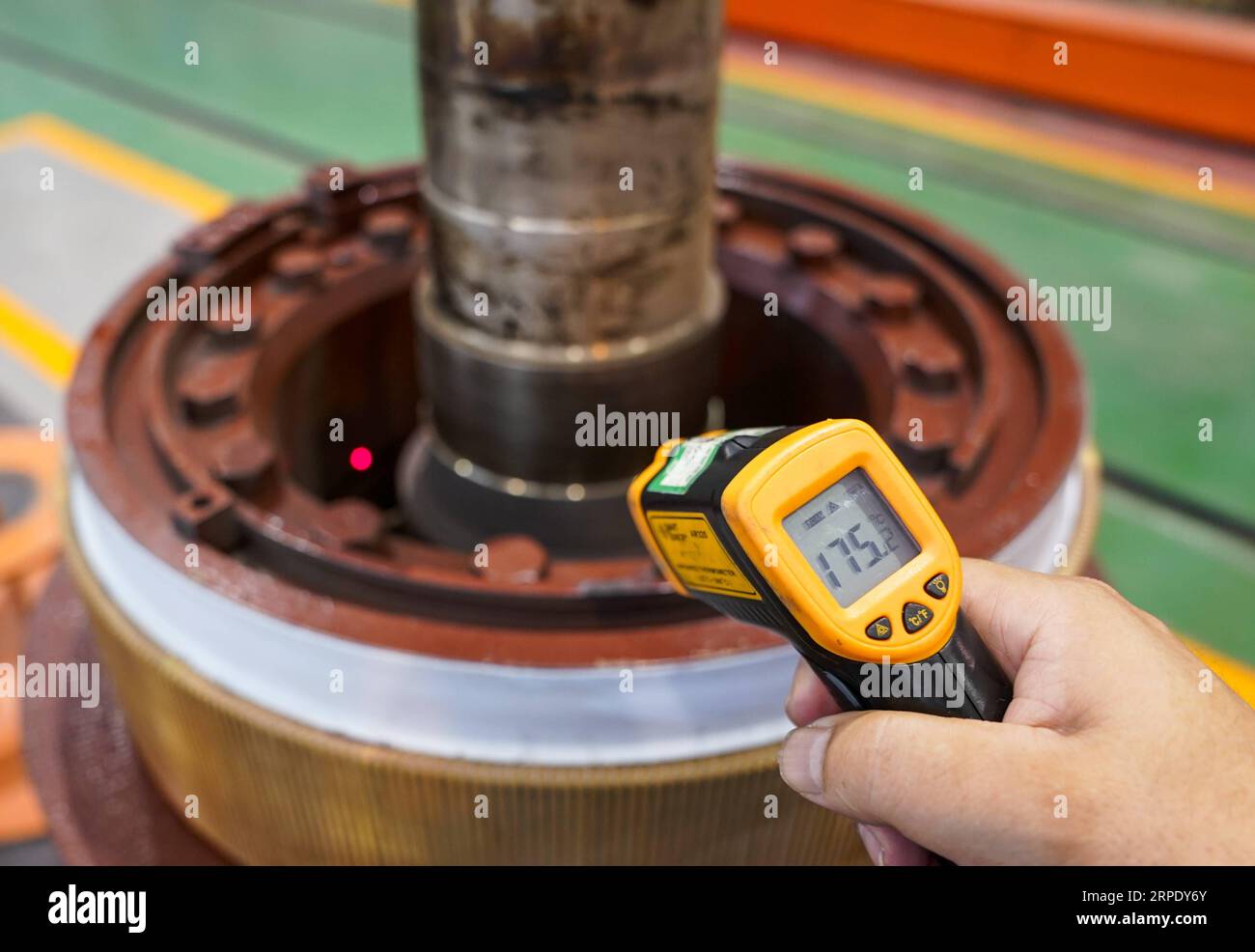 (190815) -- CHONGQING, Aug. 15, 2019 -- A worker measures the temperature of an armature at a maintenance workshop of large-size locomotive components of China Railway Chengdu Group in Chongqing, southwest China, Aug. 14, 2019. The maintenance work of armatures requires a high-temperature working environment, in which the insulating paint of armatures softens with 16 hours of baking at 175 degrees Celsius. To keep the temperature, workers have to carry out cleaning and polishing operations without any cooling devices. Chongqing recently has issued several orange alerts for continuous high temp Stock Photo
