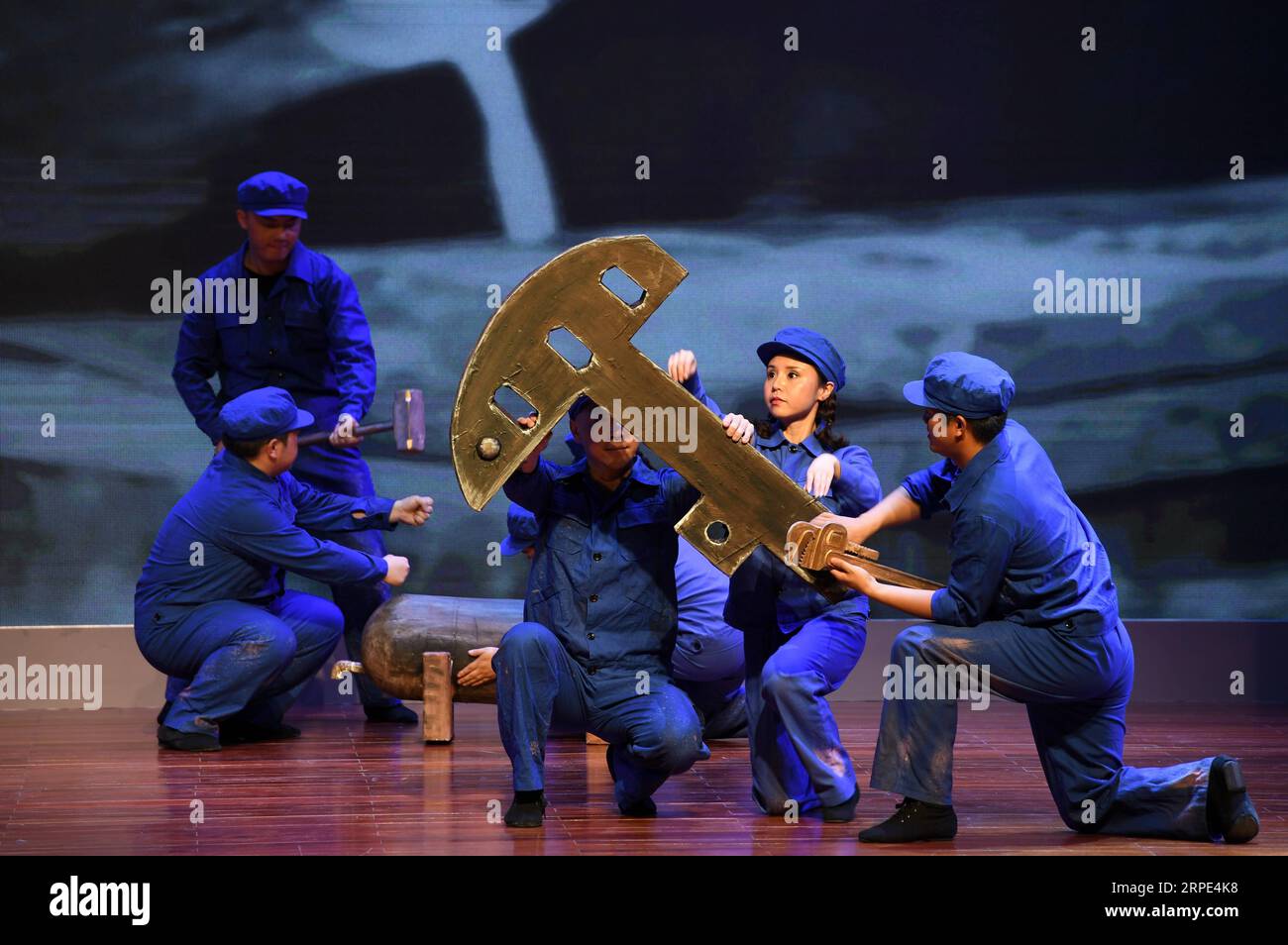 (190818) -- JIUQUAN, Aug. 18, 2019 -- Workers perform in the history-based melodrama Cradle of China s Oil held at Yumen Oilfield Culture and Sport Center in the city of Jiuquan, northwest China s Gansu Province, Aug. 17, 2019. The melodrama completely created by workers from PetroChina Yumen Oilfield Company was staged Saturday in the city, which depicts the determined spirits of oil workers in constructing the Yumen Oilfield. ) CHINA-GANSU-JIUQUAN-MELODRAMA (CN) FanxPeishen PUBLICATIONxNOTxINxCHN Stock Photo