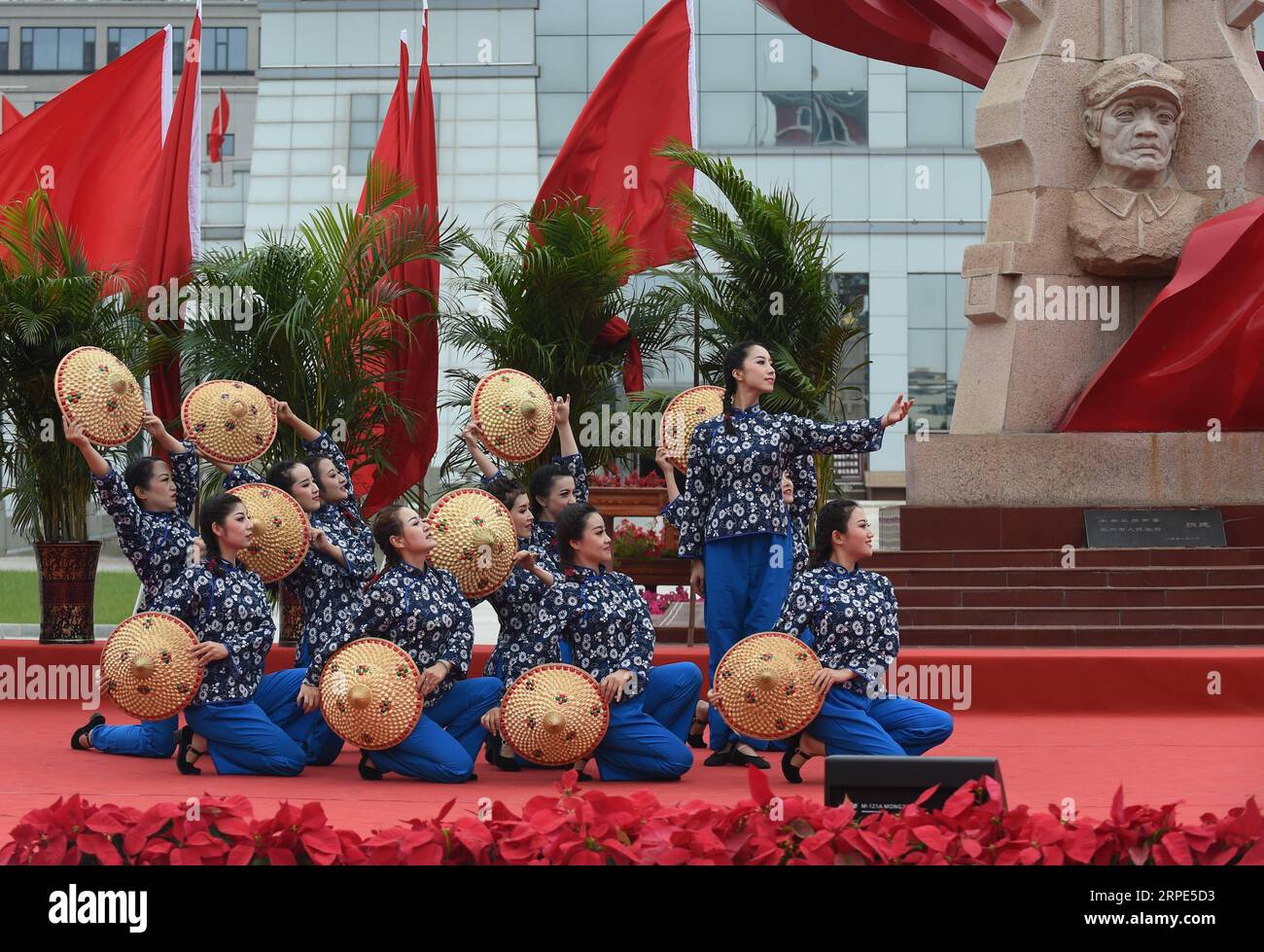 (190818) -- HUINING, Aug. 18, 2019 -- Staff members from Gansu Daily perform dance during an event marking the conclusion of an activity that took journalists to retrace the route of the Long March, in Huining, northwest China s Gansu Province, Aug. 18, 2019. The activity, held from June 11 to Aug. 18, was aimed at paying tribute to the revolutionary martyrs and passing on the traditions of revolution. The Long March was a military maneuver carried out by the Chinese Workers and Peasants Red Army from 1934 to 1936. During this period, they left their bases and marched through rivers, mountains Stock Photo