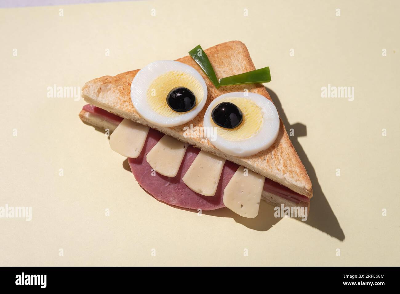 Fun Halloween monster sandwich with slice ham, eggs and cheese Stock