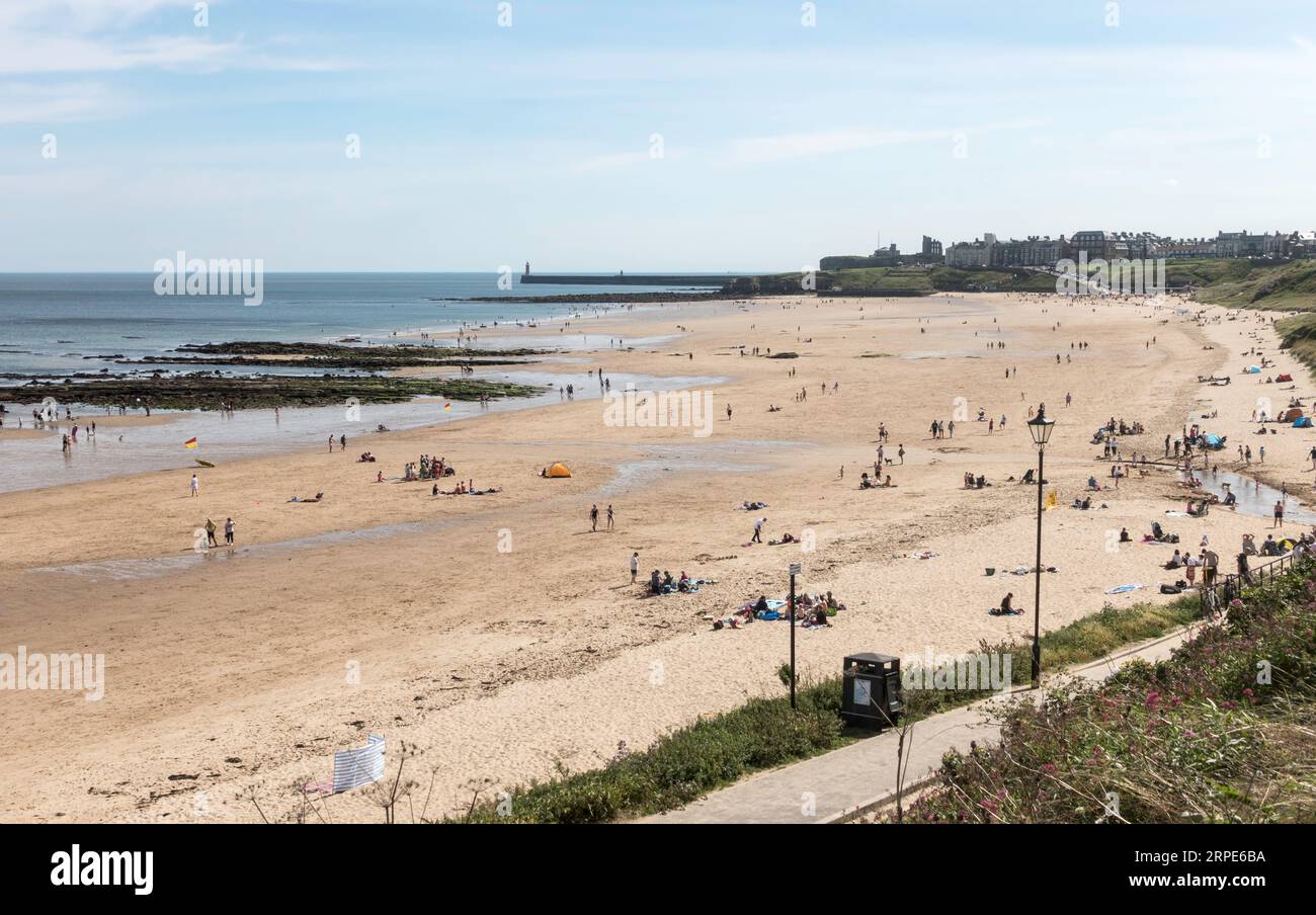 People enjoying the sun on Tynemouth Longsands beach, England, UK Stock Photo