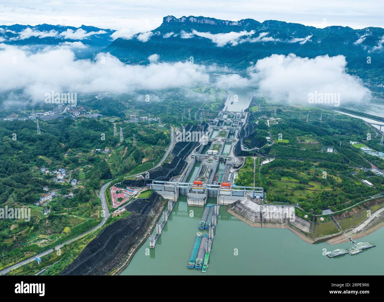 Zigui. 27th Aug, 2023. This aerial photo taken on Aug. 27, 2023 shows ships passing through the five-tier ship locks of the Three Gorges Dam in Yichang, central China's Hubei Province. The monthly cargo throughput via the five-tier ship locks at the Three Gorges Dam, the world's largest hydropower project in the upper stream of the Yangtze, reached a record high of over 15.71 million tonnes in August, according to the China Three Gorges Corporation. Credit: Zheng Jiayu/Xinhua/Alamy Live News Stock Photo