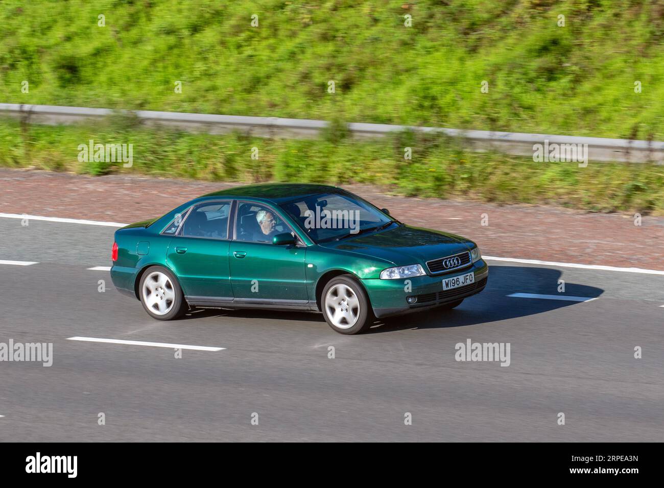 1999 Green Audi A4 Avant 2.8 Quattro sedan with unrecognised W registration; travelling at speed on the M6 motorway in Greater Manchester, UK Stock Photo