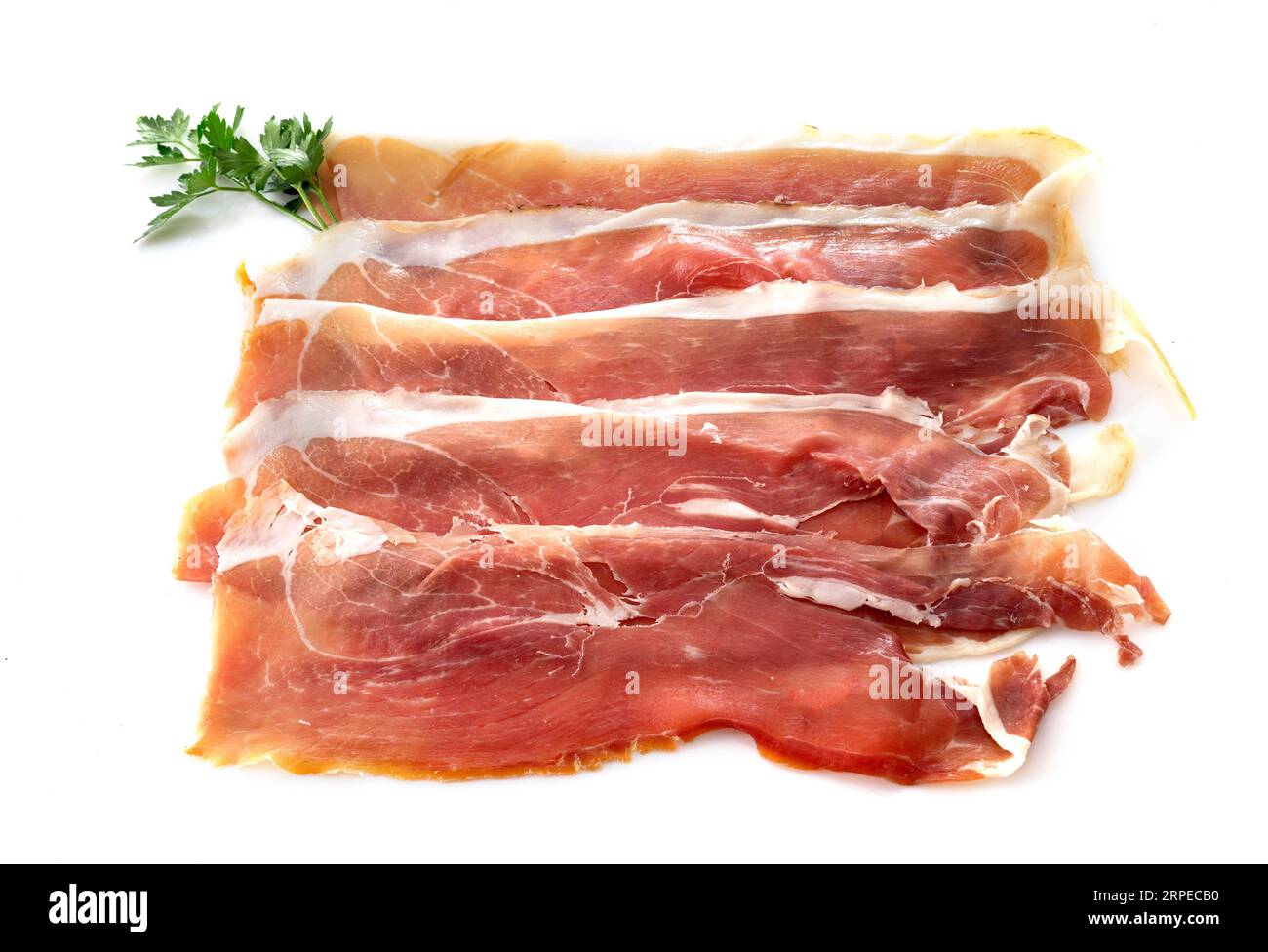slice of cured ham serano in front of white background Stock Photo