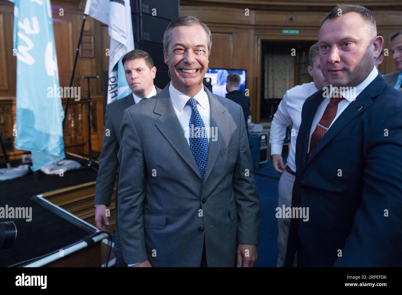(190827) -- LONDON, Aug. 27, 2019 (Xinhua) -- Brexit Party leader Nigel Farage (L, front) leaves after making a speech in London, Britain, on Aug. 27, 2019. Nigel Farage said the newly formed Brexit Party plans to contest all 650 parliamentary seats in a general election. Farage, who co-founded the anti-EU UKIP party, said the new Brexit party would be prepared to form a non-aggression pact with the Conservatives if Prime Minister Johnson pursues a no-deal Brexit. (Photo by Ray Tang/Xinhua) BRITAIN-LONDON-BREXIT PARTY PUBLICATIONxNOTxINxCHN Stock Photo