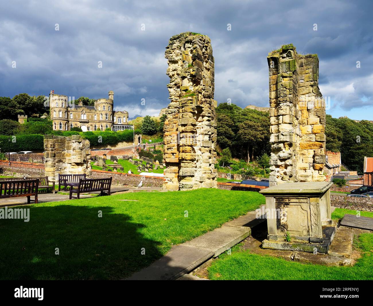 Ruins in the graveyard at St Marys Church with Castle Hill behind Scarborough North Yorkshire England Stock Photo