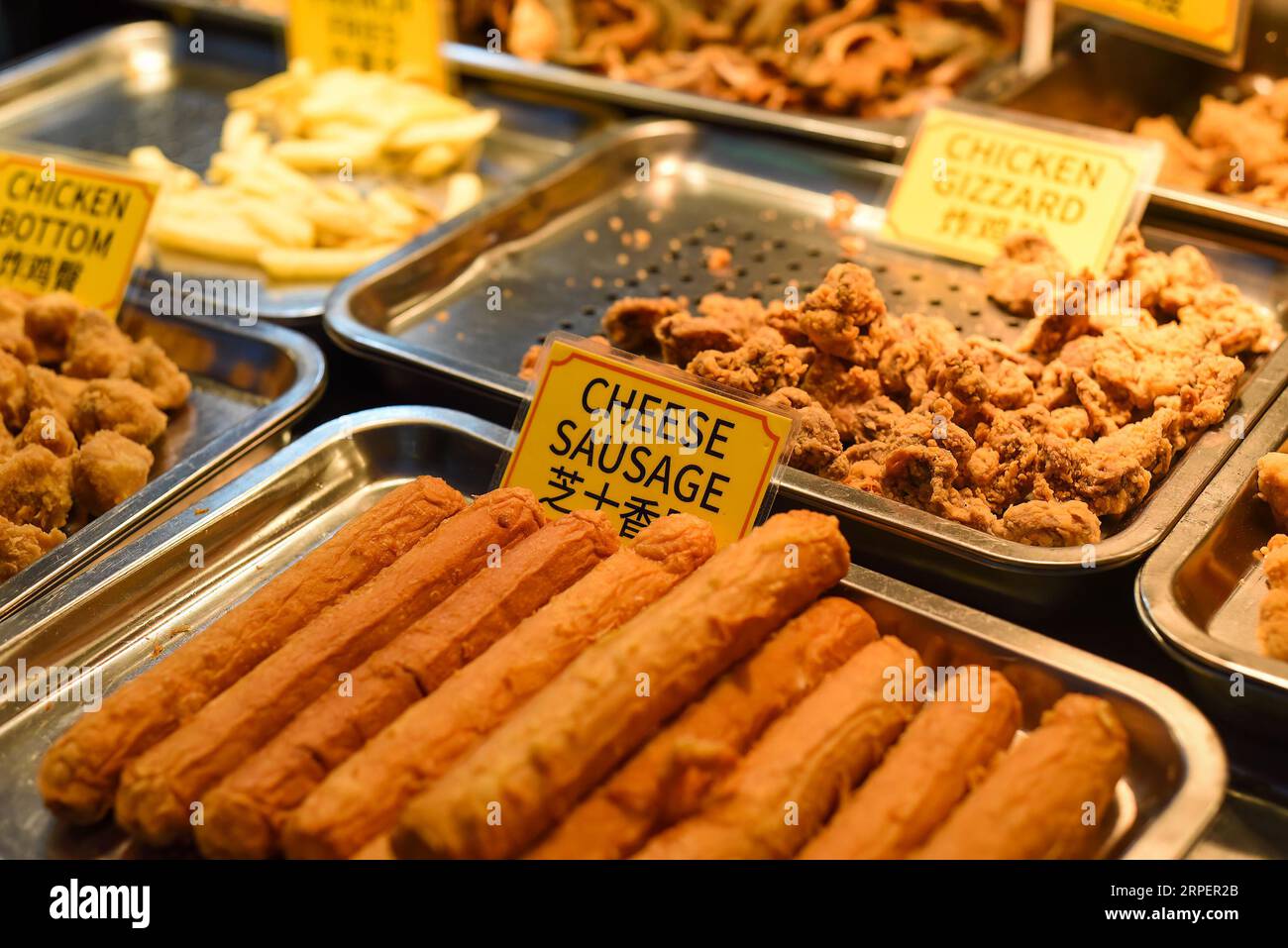 Fried cheese sausages in the street food Jalan Alor in Kuala Lumpur
