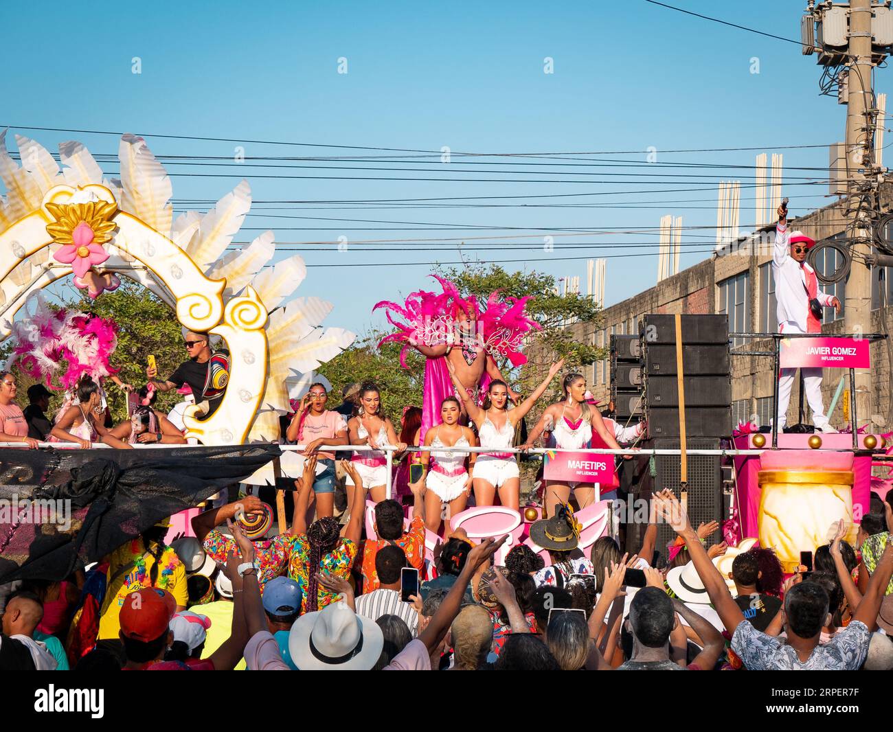 Barranquilla, Atlantico, Colombia - February 18 2023: Men and Women Dressed in White and Pink on a Float in the Carnival Parade Waving to the Crowd Stock Photo