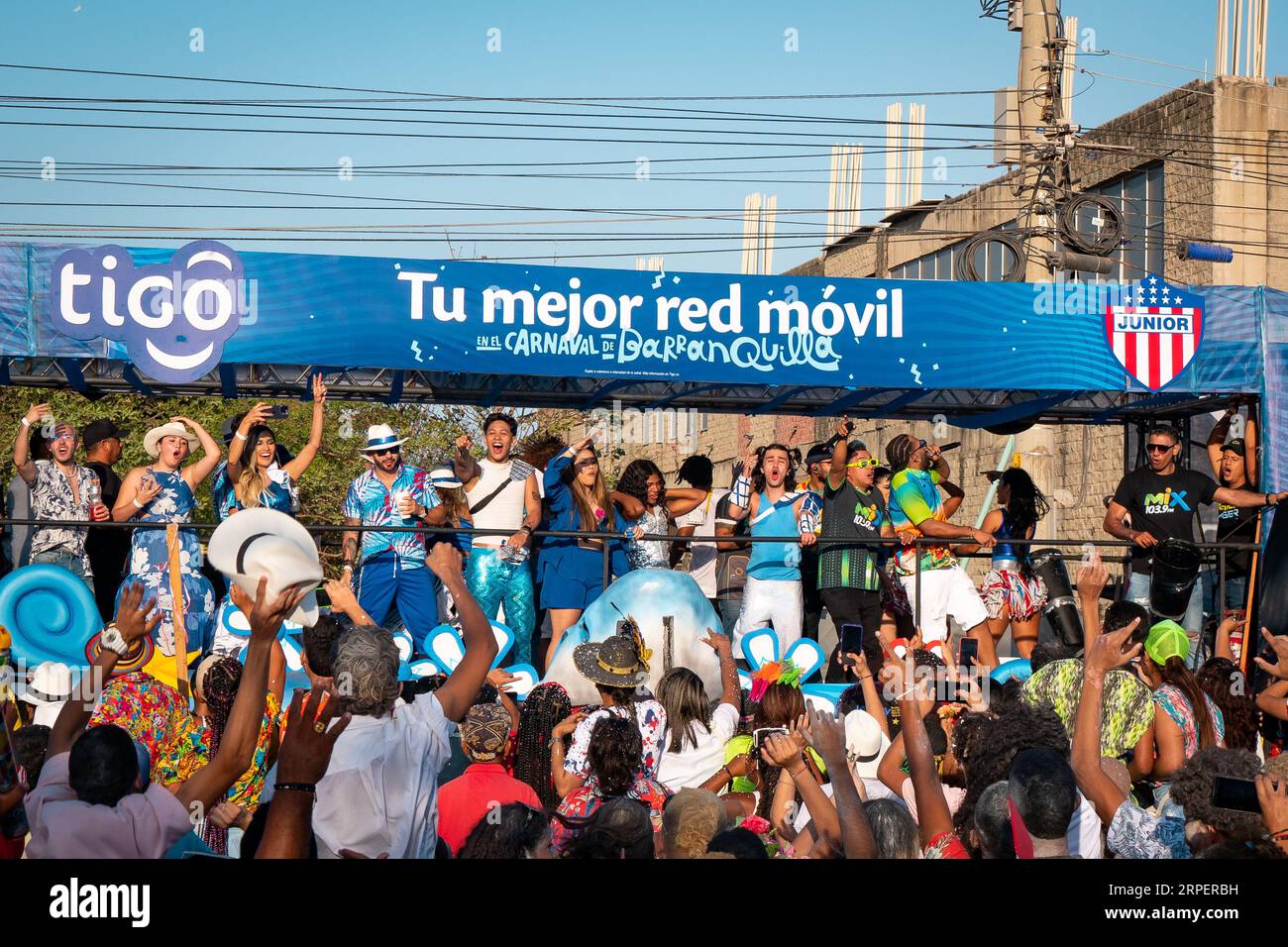 Barranquilla, Atlantico, Colombia - February 18 2023: Men and Women Dressed in Blue on a Float in the Carnival Parade Wave to a Crowd Stock Photo
