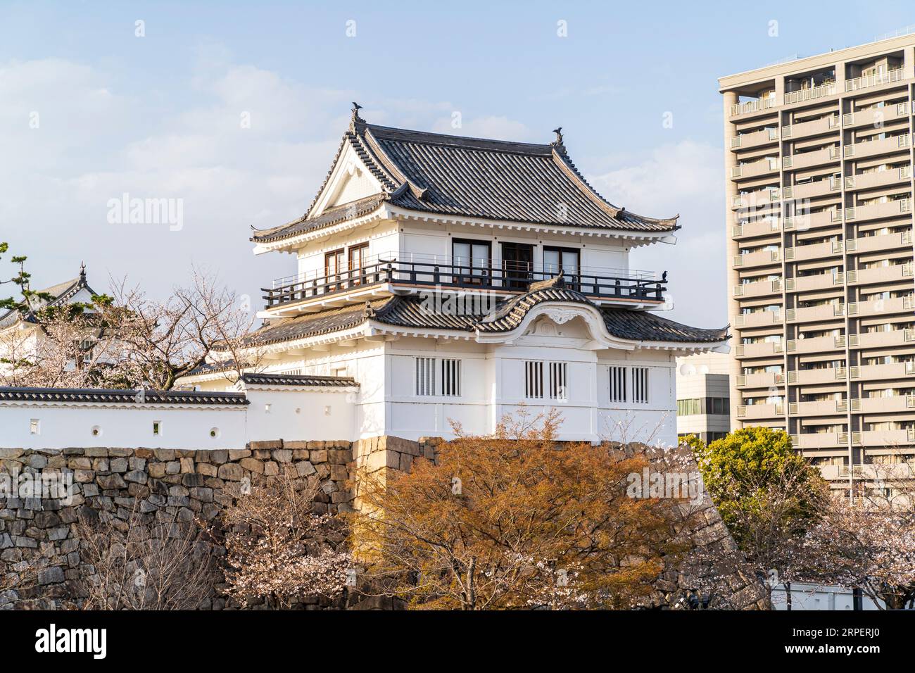 Tsukimi yagura, moon viewing Turret, at Fukuyama castle. A two story turret with a viewing balcony on the first floor. Blue sky and cherry blossom. Stock Photo