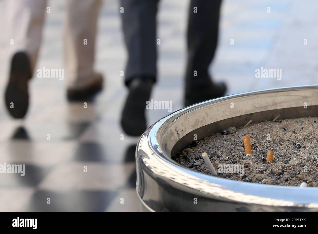 (190904) -- LISBON, Sept. 4, 2019 -- Cigarette butts are seen in a public ashtray on the sidewalk of a street in Lisbon, Portugal, on Sept. 4, 2019. Portugal introduced on Wednesday a strict law aiming at combating smokers who throw the cigarette butts on the ground in public. The new law that approves measures for the collection and treatment of the tobacco waste enters into force on Wednesday. Whoever throws on the floor will be punished with fines between 25 and 250 euros (27.6 U.S. dollars to 276 U.S. dollars). (Photo by Pedro Fiuza/Xinhua) PORTUGAL-LISBON-LAW-CIGARETTE BUTTS THROWER Petro Stock Photo