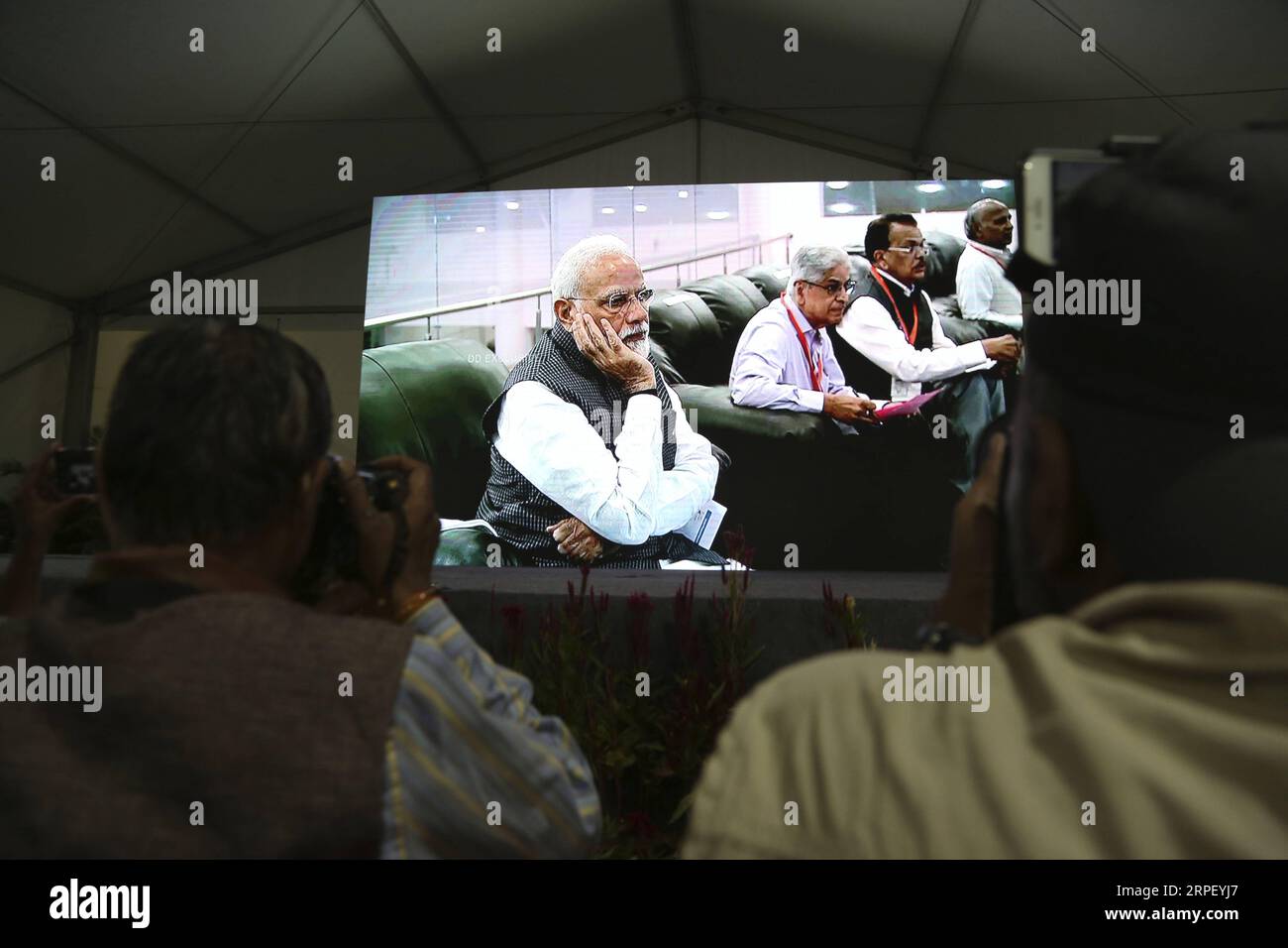 (190907) -- BANGALORE, Sept. 7, 2019 (Xinhua) -- Indian Prime Minister Narendra Modi is seen on a TV screen as he watches the live broadcast of the landing process of Chandrayaan-2 s Lander Vikram on the moon surface in Bangalore, India, Sept. 7, 2019. India s second Moon mission, Chandrayaan-2 s Lander Vikram, lost communication with the ground station at an altitude of 2.1 kilometers from the Lunar surface, said Indian Space Research Organisation (ISRO) chief K. Sivan on Saturday. Vikram was scheduled to land on the moon surface at around 01:55 a.m. (Indian Standard Time). (Str/Xinhua) (SCI- Stock Photo