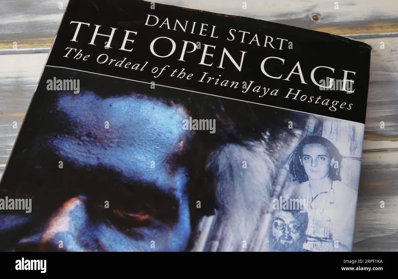 Viersen, Germany - July 9. 2023: Closeup of book cover of Daniel Start the open cage about hostage taking experience in Irian Jaya Stock Photo