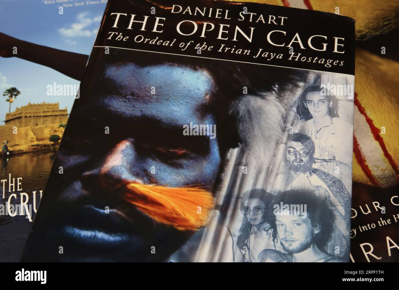 Viersen, Germany - July 9. 2023: Closeup of book cover of Daniel Start the open cage about hostage taking experience in Irian Jaya Stock Photo