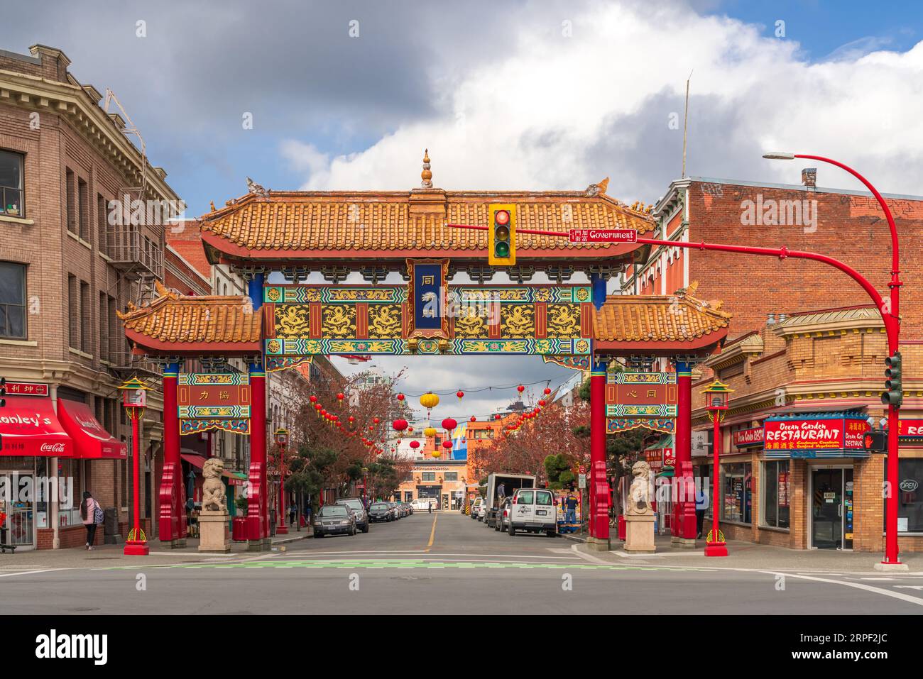 A view down Fisgard Street with the Chinese gate in Chinatown, Victoria, Vancouver Island, British Columbia, Canada. Stock Photo