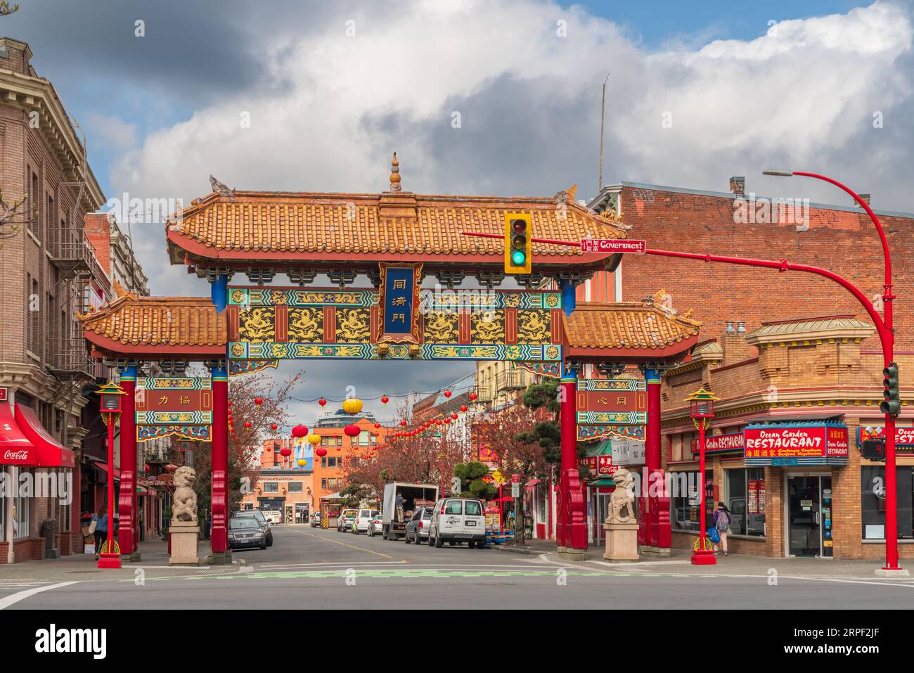 A view down Fisgard Street with the Chinese gate in Chinatown, Victoria, Vancouver Island, British Columbia, Canada. Stock Photo
