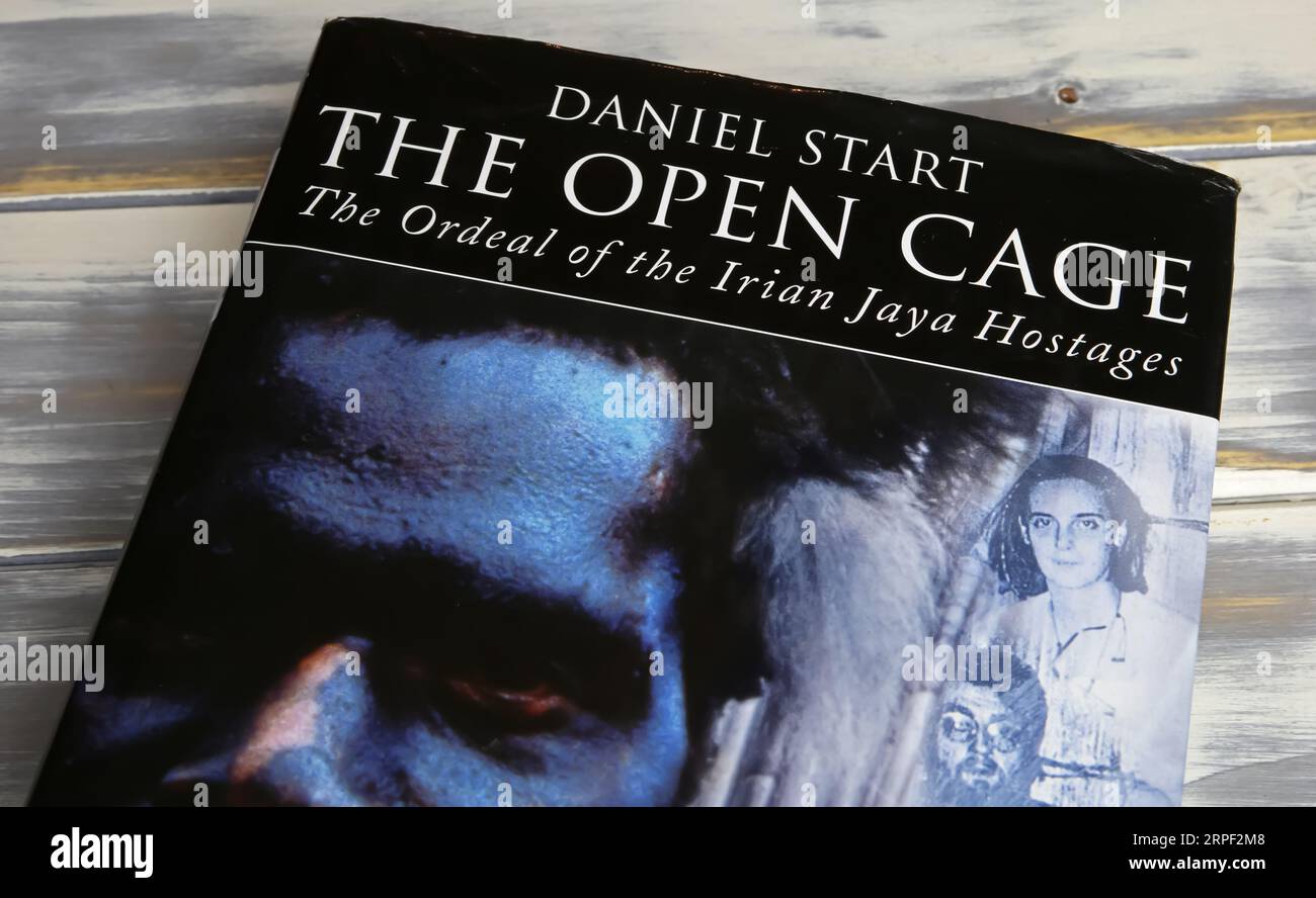 Viersen, Germany - July 9. 2023: Closeup of book cover of Daniel Start the open cage about hostage taking experience in Irian Jaya Stock Photo