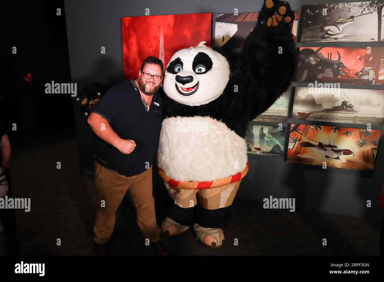 (190911) -- CANBERRA, Sept. 11, 2019 -- A visitor poses with the character in Kung Fu Panda , at an exhibition on DreamWorks Animation in the National Museum of Australia (NMA) in Canberra, Australia, Sept. 11, 2019. NMA will launch the DreamWorks Animation: The Exhibition on Thursday. Running until Feb. 2, 2020, the exhibition features more than 400 items from 33 DreamWorks Animation films, including Shrek, Madagascar, Kung Fu Panda, Prince of Egypt, How to Train Your Dragon. TO GO WITH Feature: Walking into the world of Shrek and Kung Fu Panda ) AUSTRALIA-CANBERRA-EXHIBITION-DREAMWORKS ANIMA Stock Photo