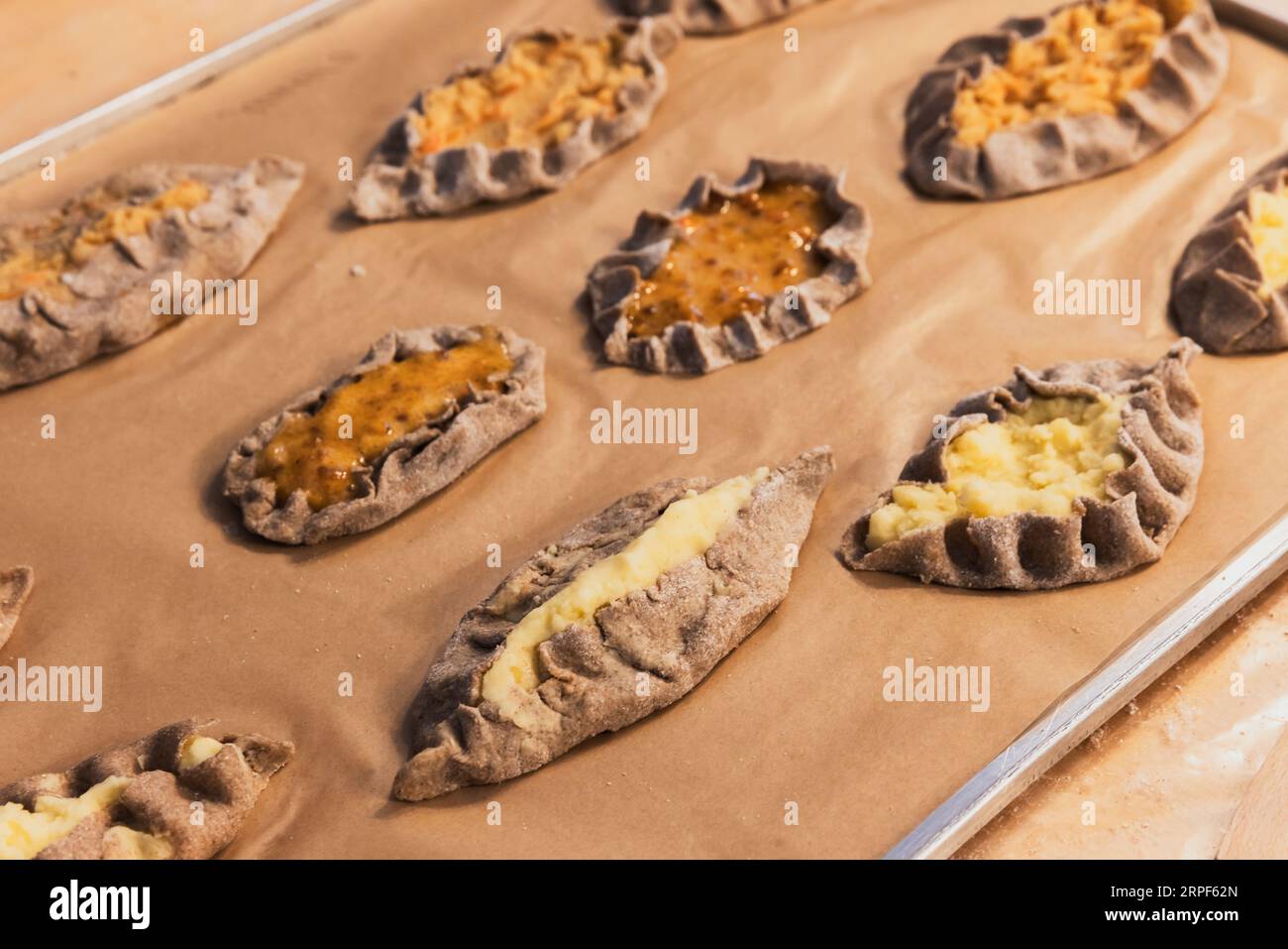 Karelian pasties with mashed potato and carrot filling, close up photo with selective soft focus Stock Photo