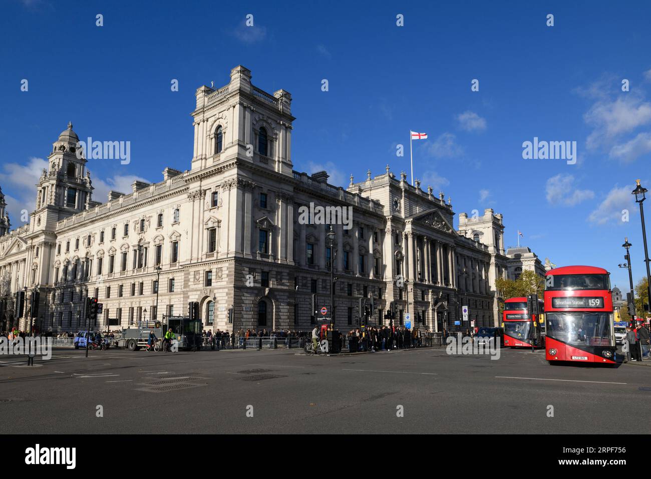 A New Routemaster bus crossing Parliament Sq with the 'Government Offices Great George Street', (GOGGS) in the background.   GOGGS is a large UK gover Stock Photo