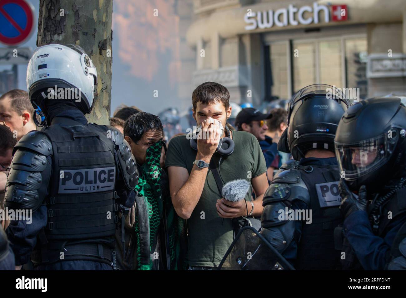190921 -- PARIS, Sept. 21, 2019 -- A demonstrator faces police officers on the Champs Elysees in Paris, France, Sept. 21, 2019. French police had arrested 137 individuals in Paris by 16:00 local time 1400 GMT, as Yellow Vest protests against President Emmanuel Macron s fiscal policy hit streets again on Saturday. In Paris, 7,500 police officers have been poured in and armored vehicles were deployed to handle more threats of rioting that, according to the government, risks to taint the social movement s 45th weekend of action. Photo by Aurelien Morissard/Xinhua FRANCE-PARIS-PROTEST-POLICE- YELL Stock Photo