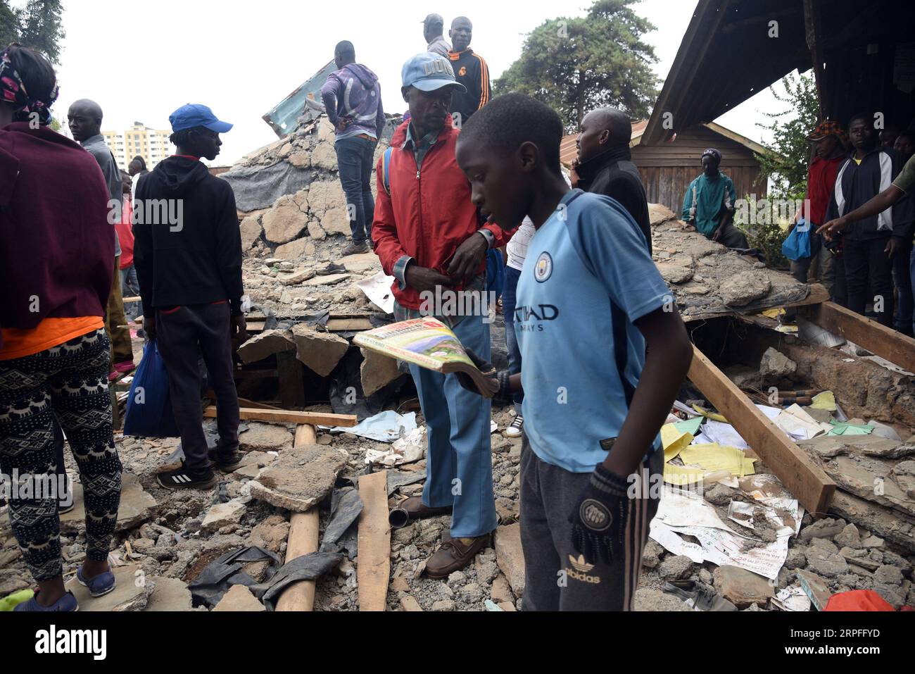 190923 -- NAIROBI, Sept. 23, 2019 Xinhua -- People stand at the scene where a classroom collapsed in Nairobi, capital of Kenya, on Sept. 23, 2019. At least seven pupils were killed and 59 others injured early Monday after their classroom collapsed at a school compound in Nairobi, government and charity officials said. Photo by John Okoyo/Xinhua KENYA-NAIROBI-CLASSROOM-COLLAPSE PUBLICATIONxNOTxINxCHN Stock Photo