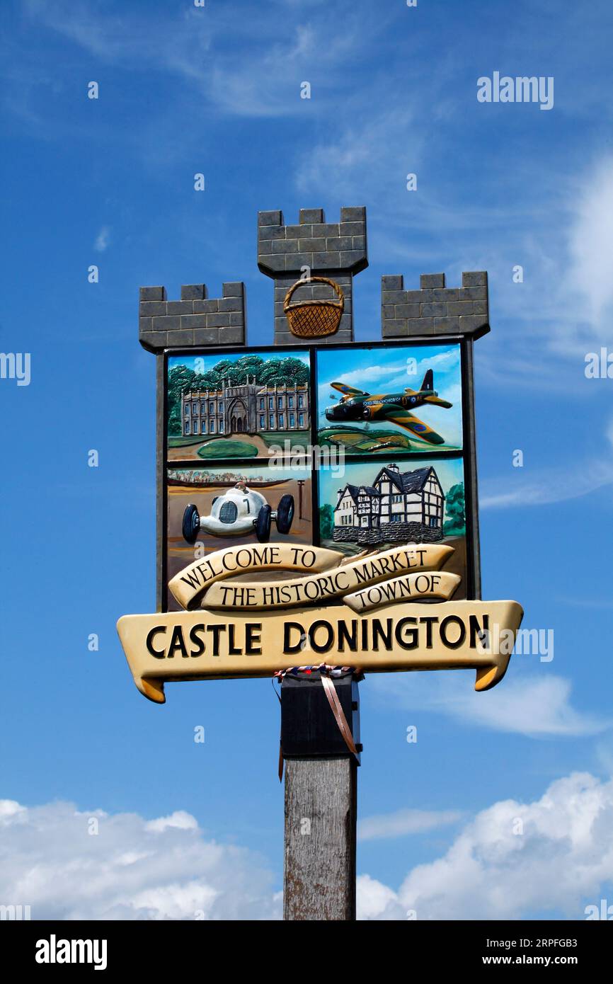 Village sign of Castle Donington showing its history with racing track, aircraft production in WW2, and stately houses. Stock Photo