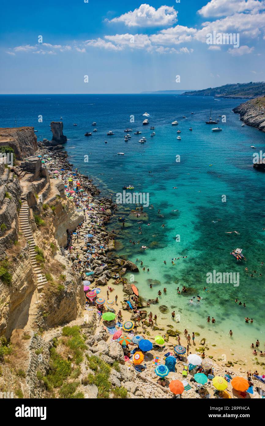 The amazing bay of Porto Miggiano, in Santa Cesarea Terme, resort of Salento, Puglia, Italy. Full of tourists and boats, in the clear, blue and turquo Stock Photo