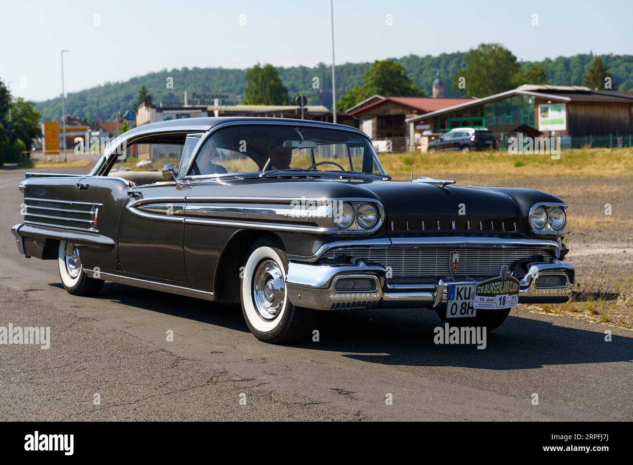 Waltershausen, Germany - June 10, 2023: A vintage American Oldsmobile Rocket Super 88 is parked in front of a Burgenland classic. Stock Photo