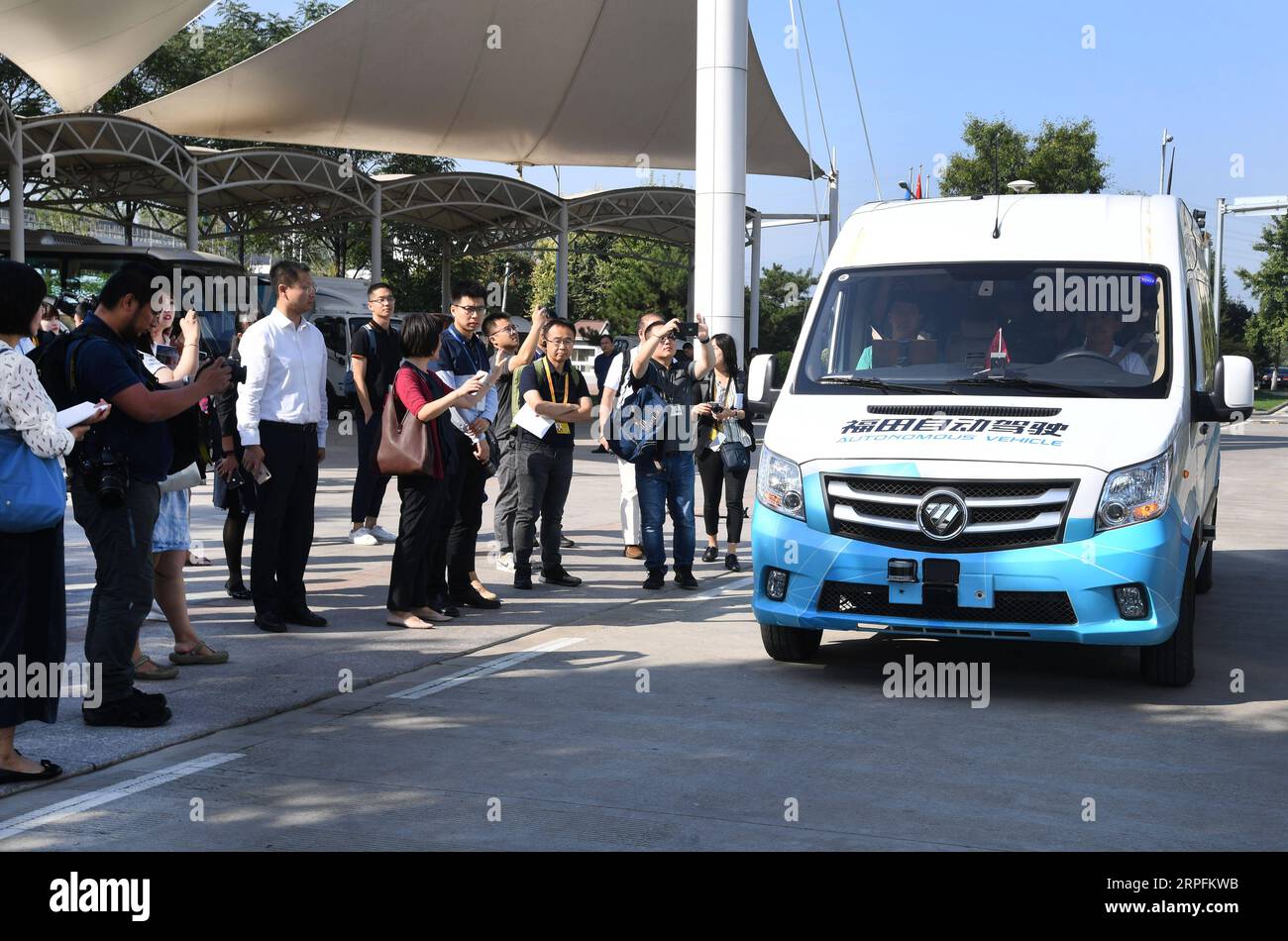 190926 -- BEIJING, Sept. 26, 2019 -- Journalists wait to experience a self-driving vehicle during a visit to Beiqi Foton Motor Co., Ltd. in Beijing, capital of China, Sept. 26, 2019. More than 40 journalists from home and abroad visited Foton Motor on Thursday.  CHINA-BEIJING-FOTON MOTOR-JOURNALISTS-VISIT CN RenxChao PUBLICATIONxNOTxINxCHN Stock Photo