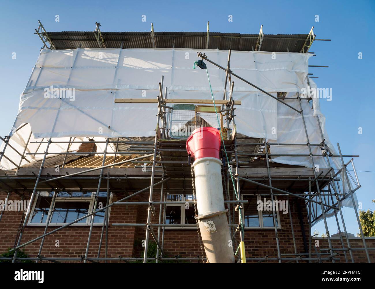Europe, UK, England, Surrey, scaffolding tin hat on house roof renovation Stock Photo Alamy
