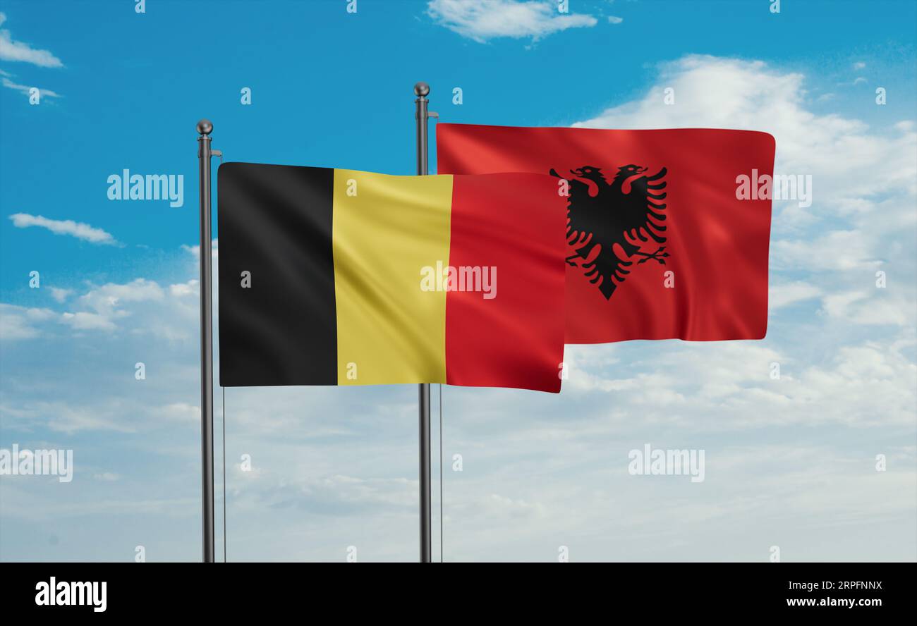Belgium flag and Albania flag waving together in the wind on blue sky ...