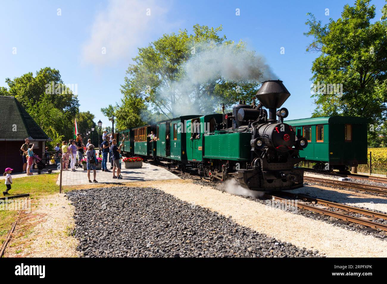 Nagycenki Szechenyi Muzeumvasut narrow gauge railway. Passenger train pulled by 'Andras' steam locomotive leaving Kastely station, Nagycenk, Hungary Stock Photo