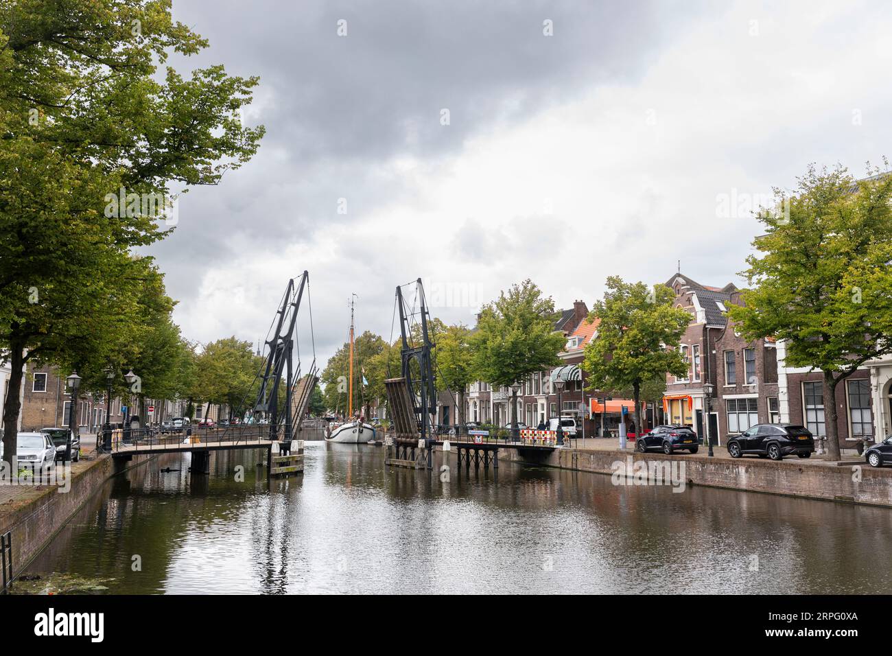 City scape of Schiedam with a draw bridge and a sail boat, Netherlands Stock Photo