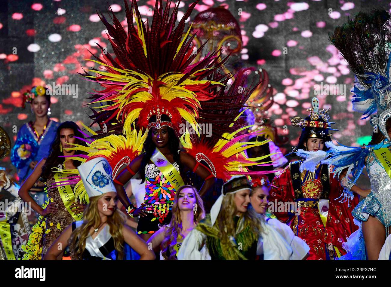 191007 -- QINGDAO, Oct. 7, 2019 -- Contestants showcase folk costume during the Miss Tourism World 2019 Global Finals in Qingdao, east China s Shandong Province, Oct. 6, 2019. The beauty pageant concluded Sunday in the coastal city Qingdao, in which Miss Tourism Mexico Michelle Hewitt Zapata won the championship, Svetlana Mamaeva from Canada won the first runner-up, and Tan Ruoyi from China won the second runner-up. Contestants from over 60 countries and regions, including the United States, Venezuela, France, Brazil, SCO Shanghai Cooperation Organization member states as well as BRI Belt and Stock Photo