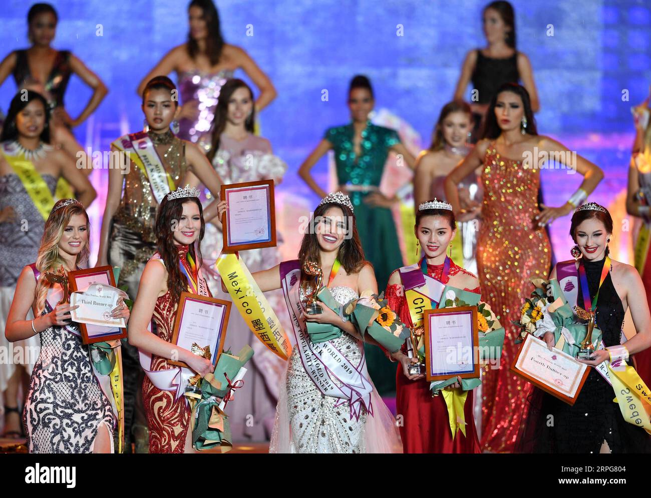 191007 -- QINGDAO, Oct. 7, 2019 -- Contestants are seen at the awarding ceremony during the Miss Tourism World 2019 Global Finals in Qingdao, east China s Shandong Province, Oct. 6, 2019. The beauty pageant concluded Sunday in the coastal city Qingdao, in which Miss Tourism Mexico Michelle Hewitt Zapata won the championship, Svetlana Mamaeva from Canada won the first runner-up, and Tan Ruoyi from China won the second runner-up. Contestants from over 60 countries and regions, including the United States, Venezuela, France, Brazil, SCO Shanghai Cooperation Organization member states as well as B Stock Photo