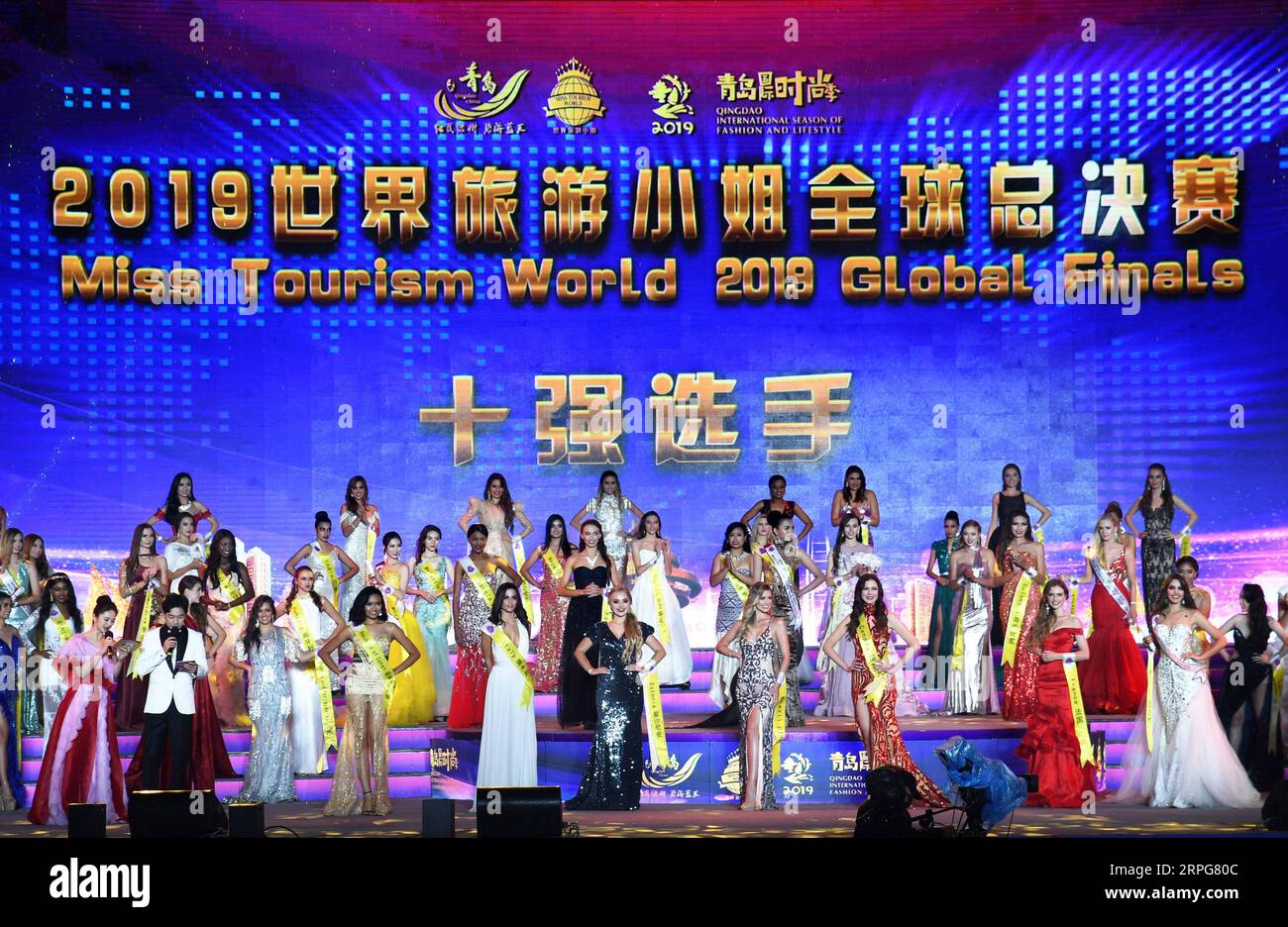 191007 -- QINGDAO, Oct. 7, 2019 -- Contestants are seen at the awarding ceremony during the Miss Tourism World 2019 Global Finals in Qingdao, east China s Shandong Province, Oct. 6, 2019. The beauty pageant concluded Sunday in the coastal city Qingdao, in which Miss Tourism Mexico Michelle Hewitt Zapata won the championship, Svetlana Mamaeva from Canada won the first runner-up, and Tan Ruoyi from China won the second runner-up. Contestants from over 60 countries and regions, including the United States, Venezuela, France, Brazil, SCO Shanghai Cooperation Organization member states as well as B Stock Photo