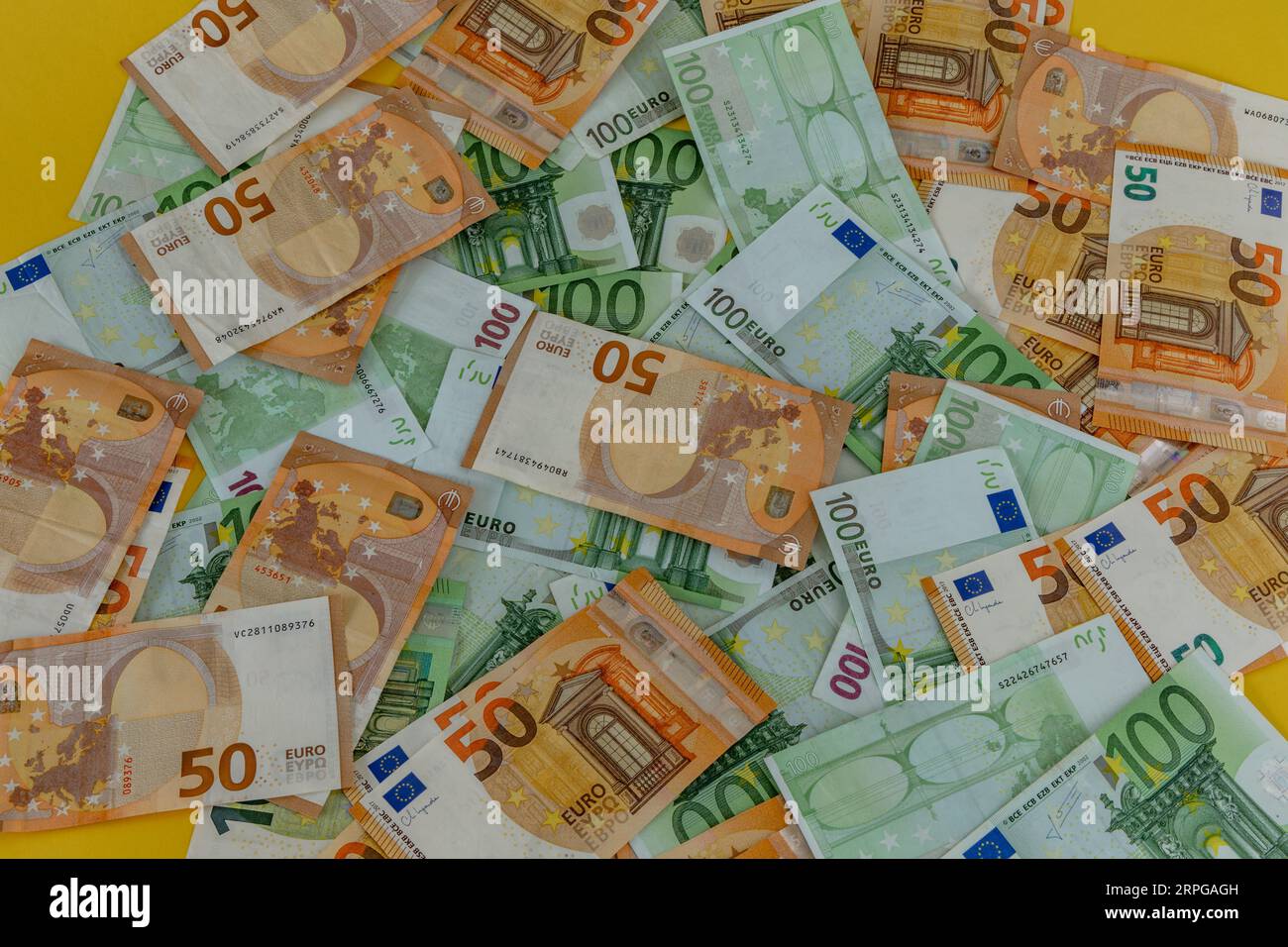 Money scattered on the table one hundred and two hundred Euro banknotes Stock Photo