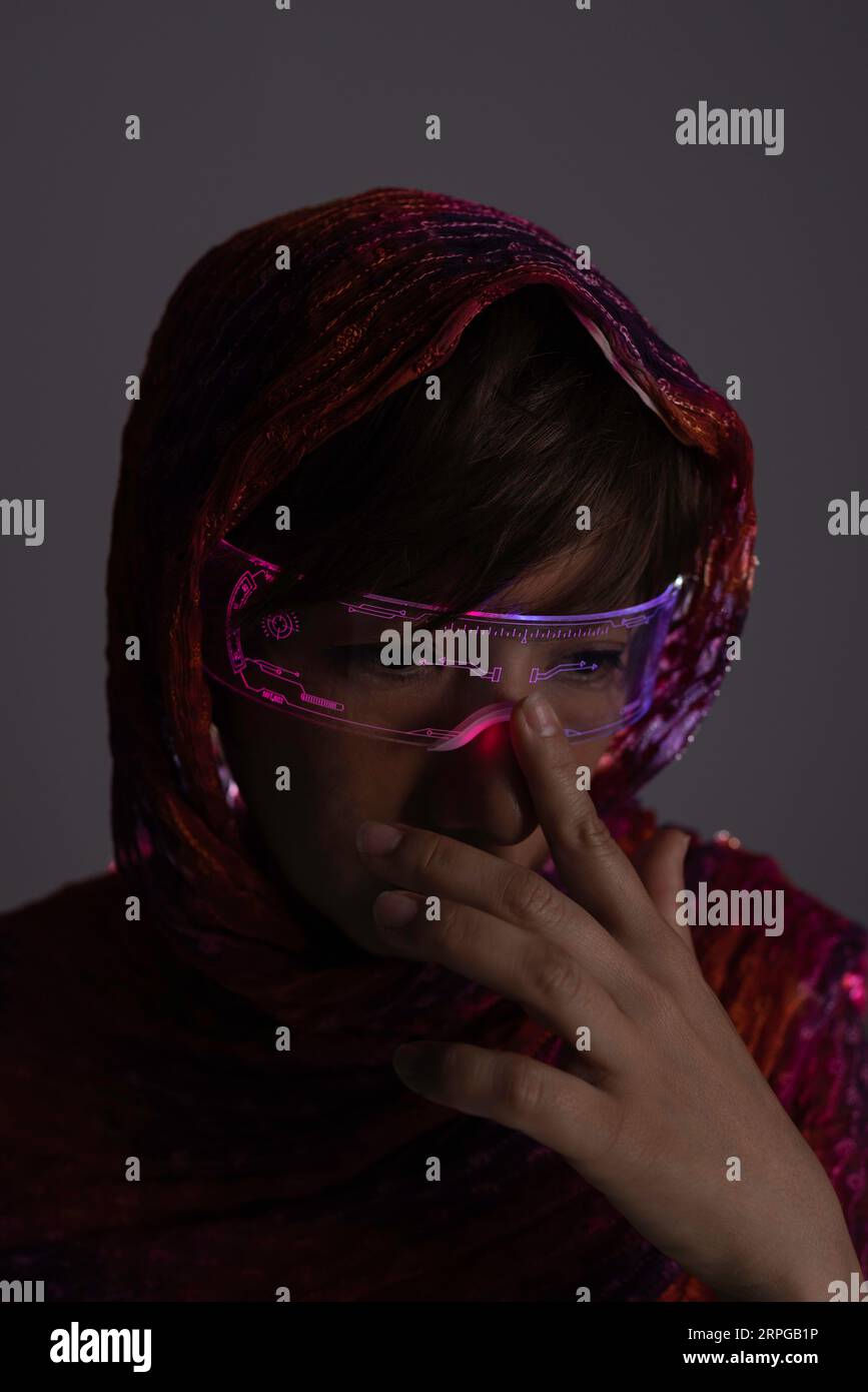 Woman in the dark with luminous glasses Stock Photo