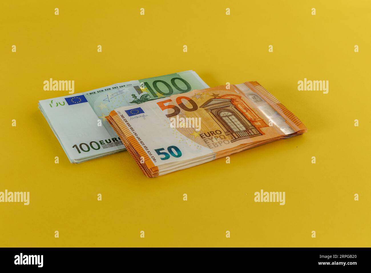 Money scattered on the table one hundred and two hundred Euro banknotes Stock Photo