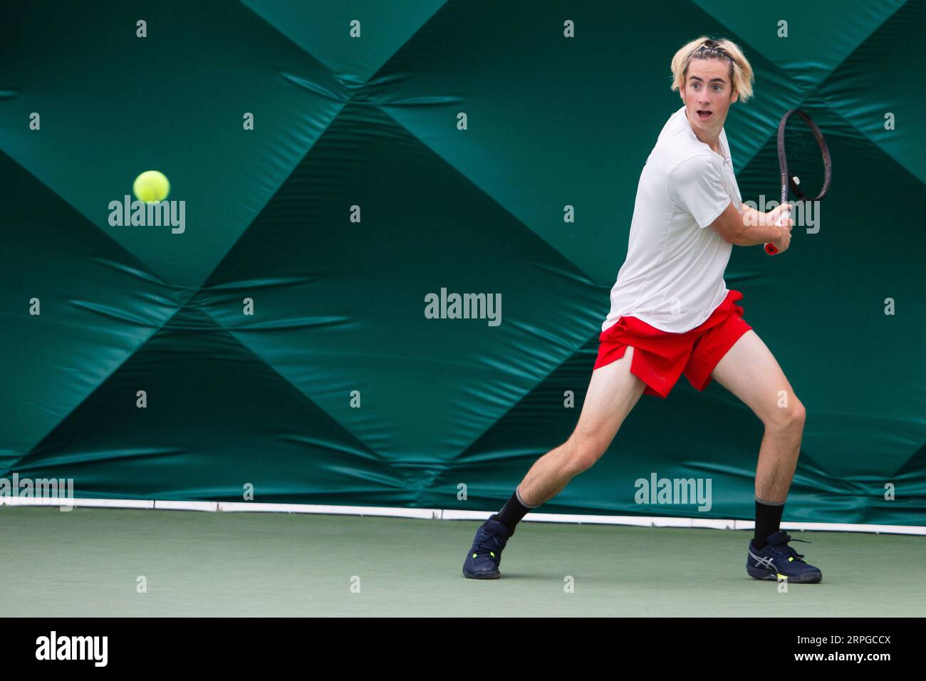 Tennis player hitting the tennis ball during a match Stock Photo Alamy