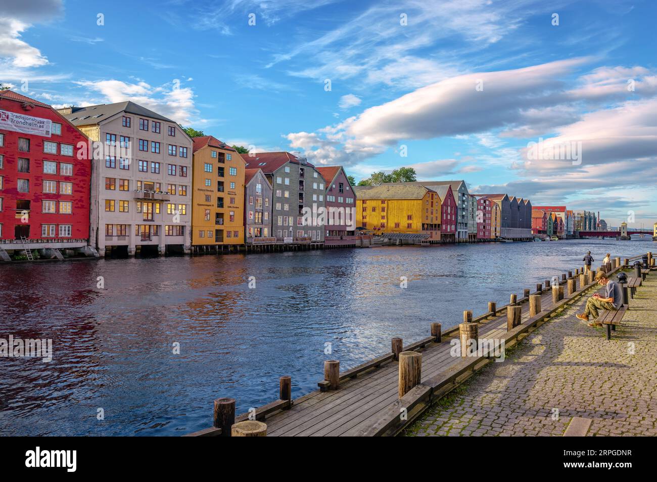 Trondheim, Norway - August 19 2022: River Nidelva, with the inner city's iconic waterside warehouses on a sunny afternoon. Stock Photo