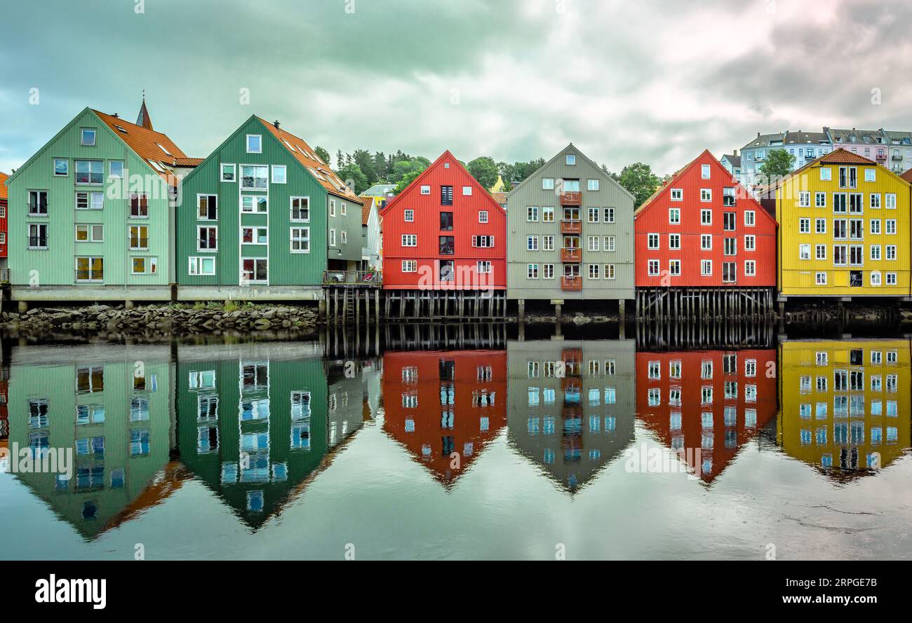 The inner city's iconic waterside warehouses by the river Nidelva, the most distinctive historical vernacular building types in Trondheim, Norway. Stock Photo